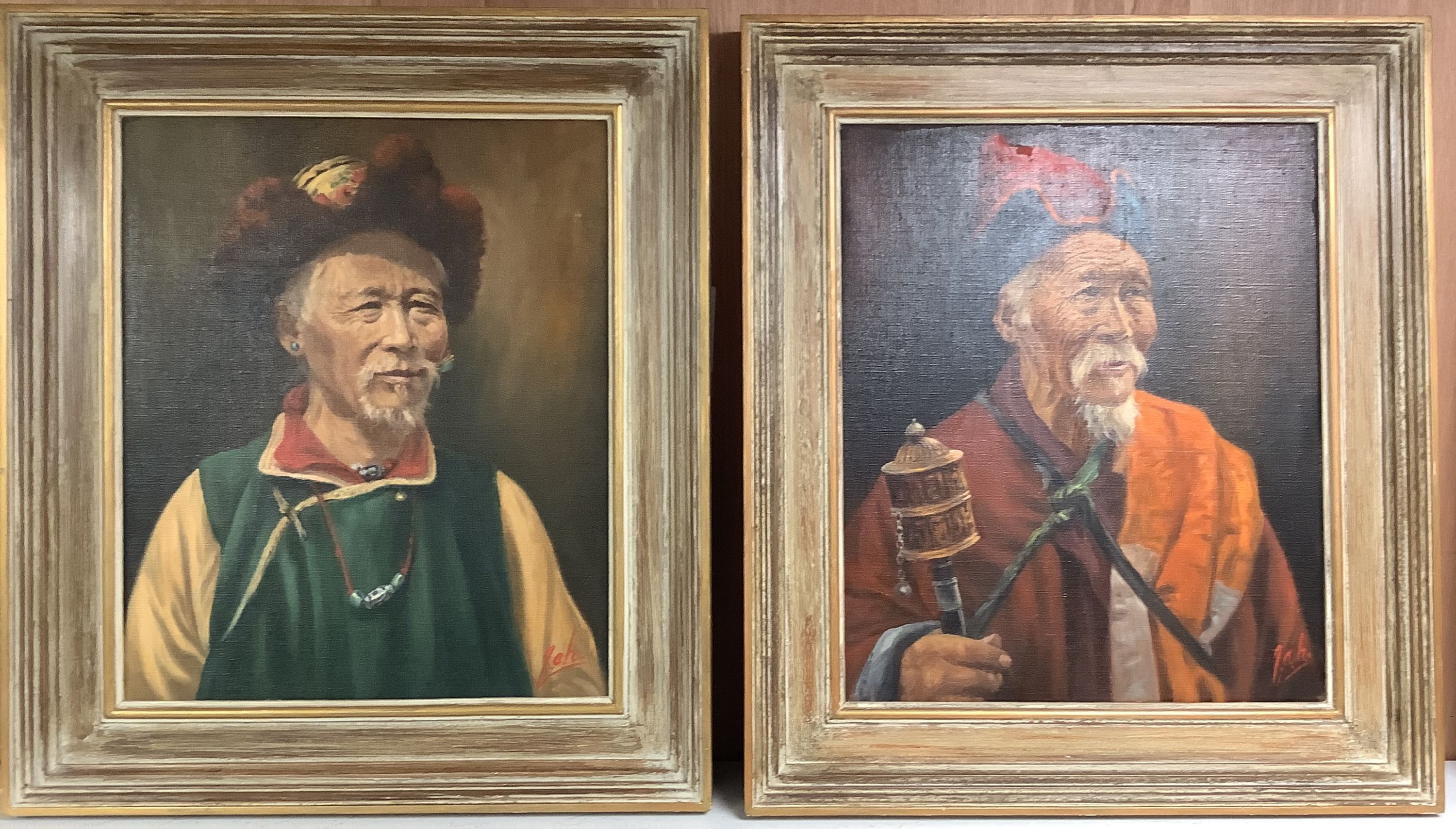 A pair of oils on canvas of Tibetan figures holding prayer wheels, 44.5 x 36cm